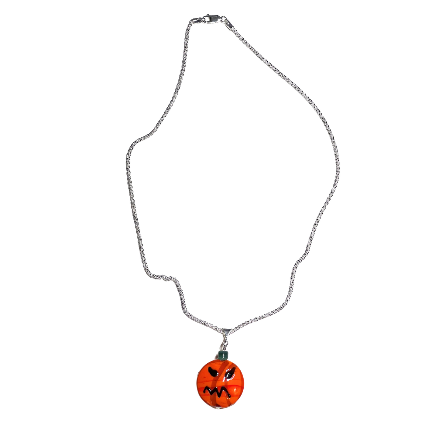 Pumpkin-shaped pendant on a chain against a white background