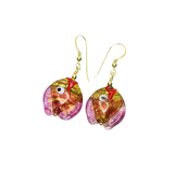 a pair of earrings with a fish design