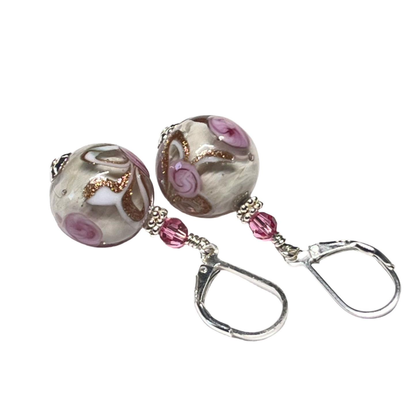 A pair of Murano glass earrings with pink rose designs and silver findings, displayed against a white background.