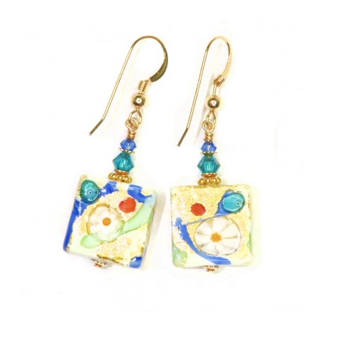 a pair of earrings with a picture on it