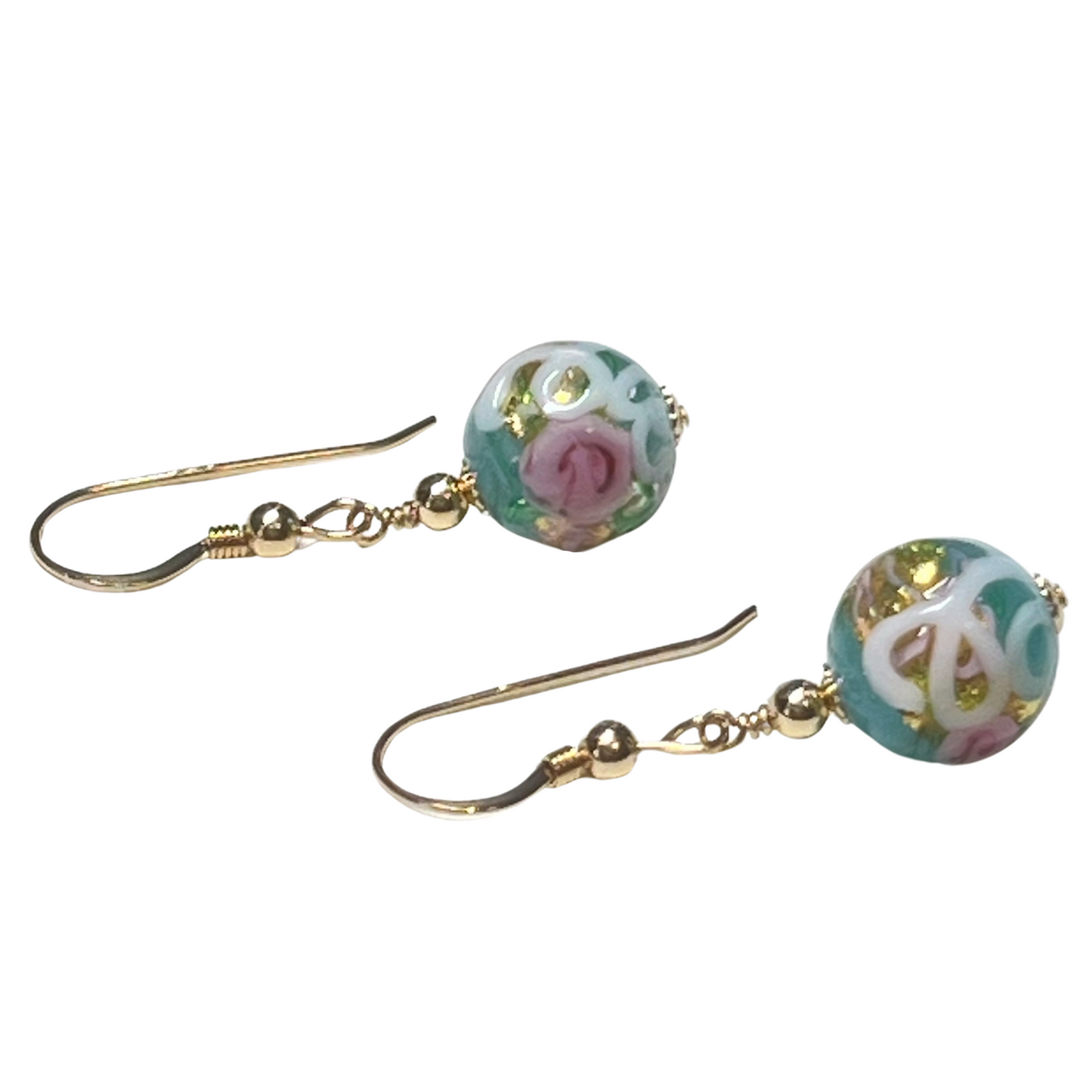 Pair of earrings with floral design beads on a white background