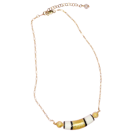 a yellow gold and white necklace on a gold chain