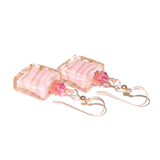 a pair of pink earrings with pink beads