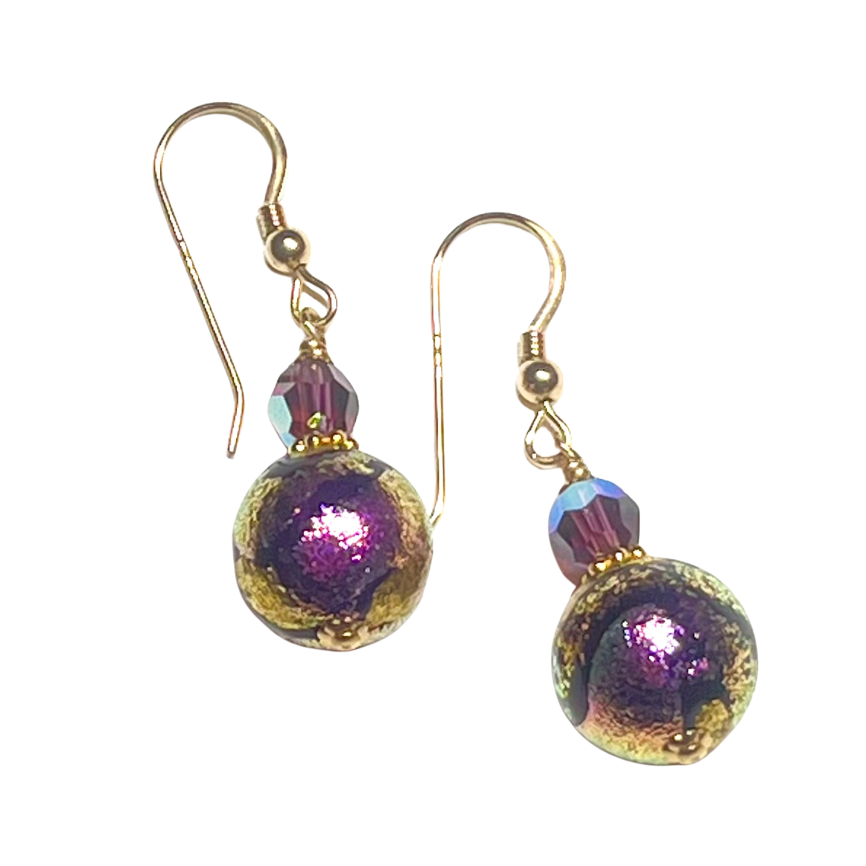 Pair of gold earrings with purple and gold beads on a white background