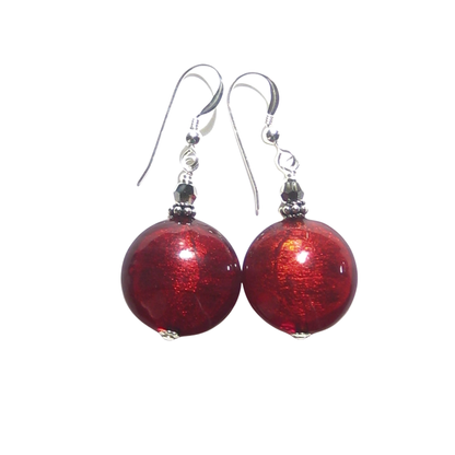 A pair of Murano glass dangling earrings featuring round, glossy red glass beads, suspended from silver fishhook wires with small dark metallic spacer beads, set against a plain white background.