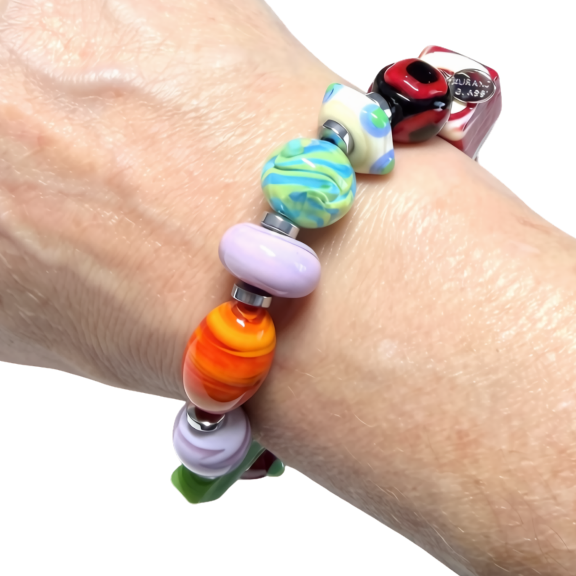 A close-up of a person's wrist wearing a colorful beaded stretch bracelet. The bracelet features multiple glossy glass beads in various patterns and colors, including orange, yellow, green, purple, red, and white swirls, separated by small silver metal spacers.