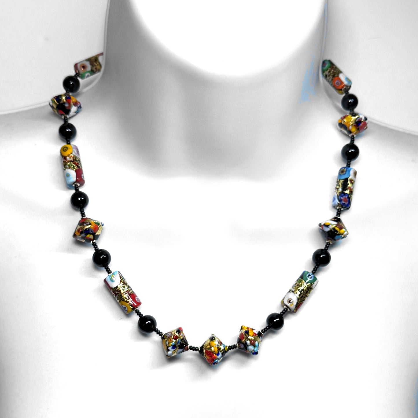 Colorful beaded necklace on a white mannequin