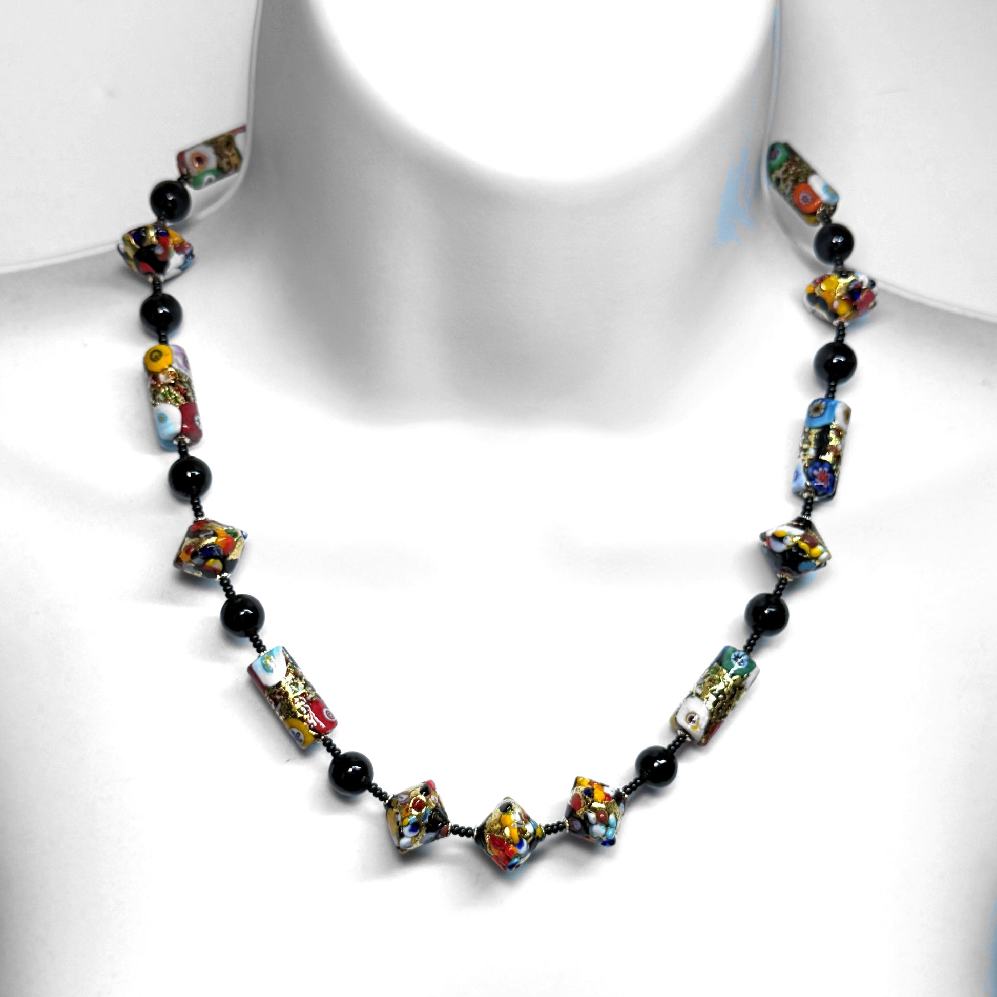 Colorful beaded necklace on a white mannequin