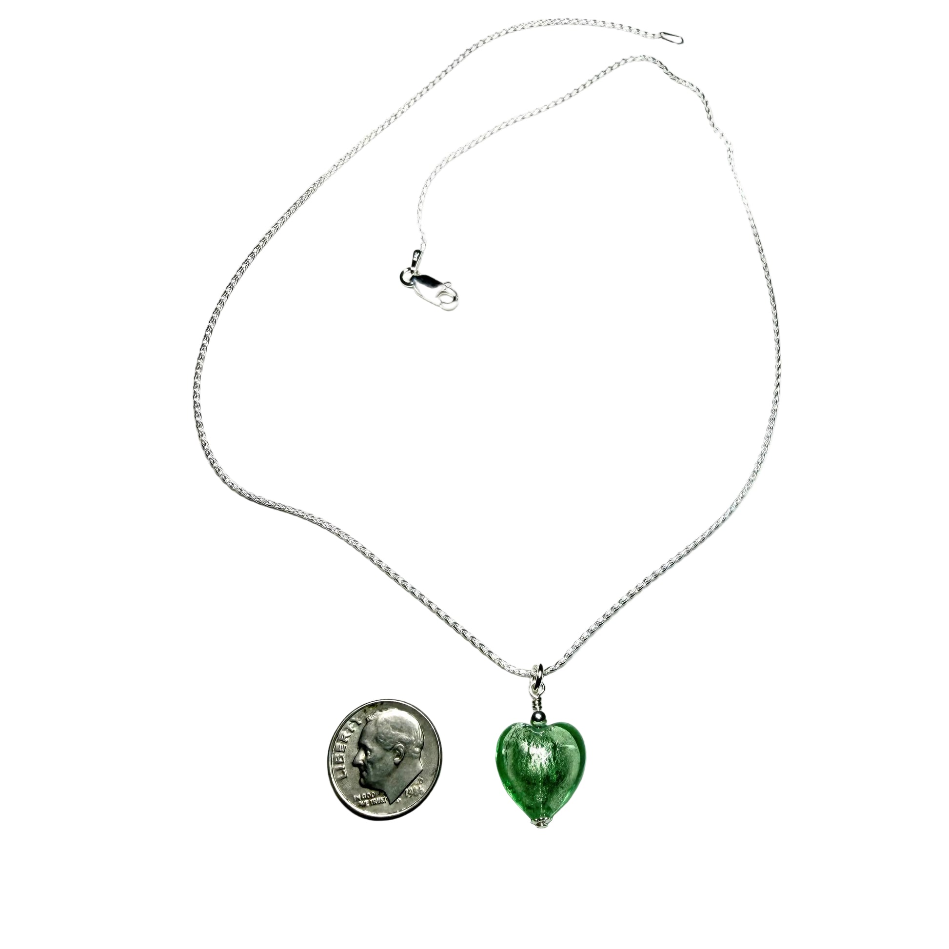 Necklace with a green heart-shaped pendant and a coin pendant on a white background