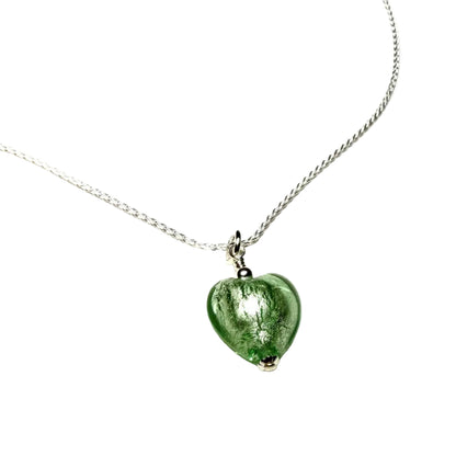 Green heart-shaped pendant on a silver chain against a white background