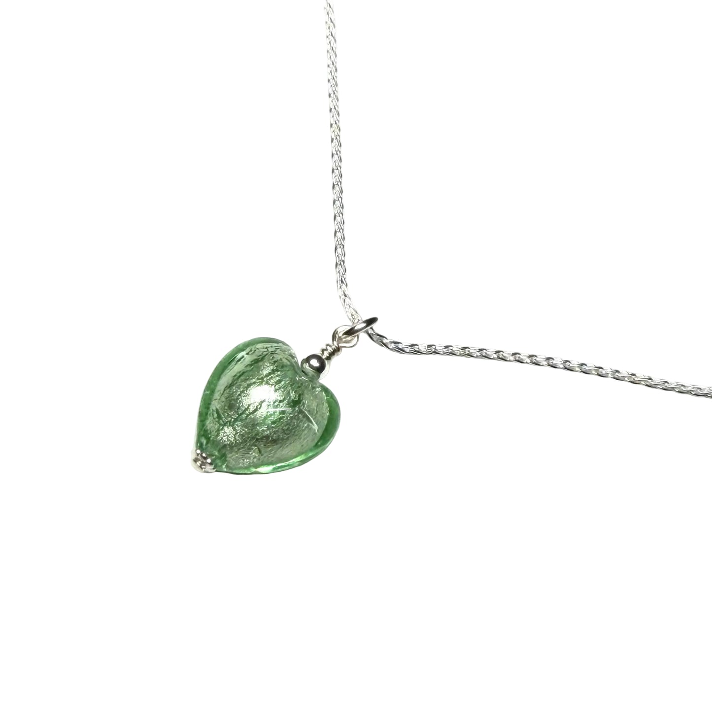 Green heart-shaped pendant on a silver chain against a white background