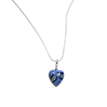 Heart-shaped blue pendant on a silver chain against a white background