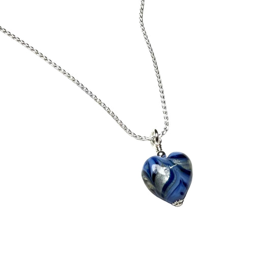 Heart-shaped blue and silver pendant on a chain against a white background