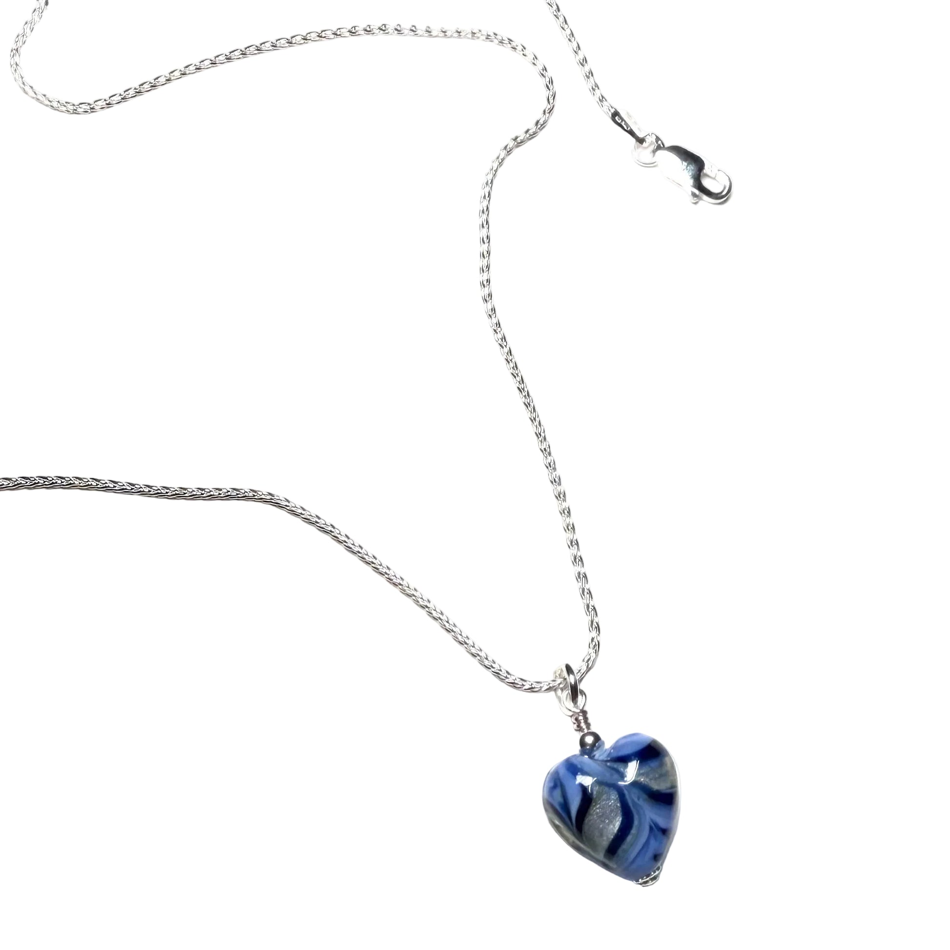 Heart-shaped blue pendant on a silver chain against a white background