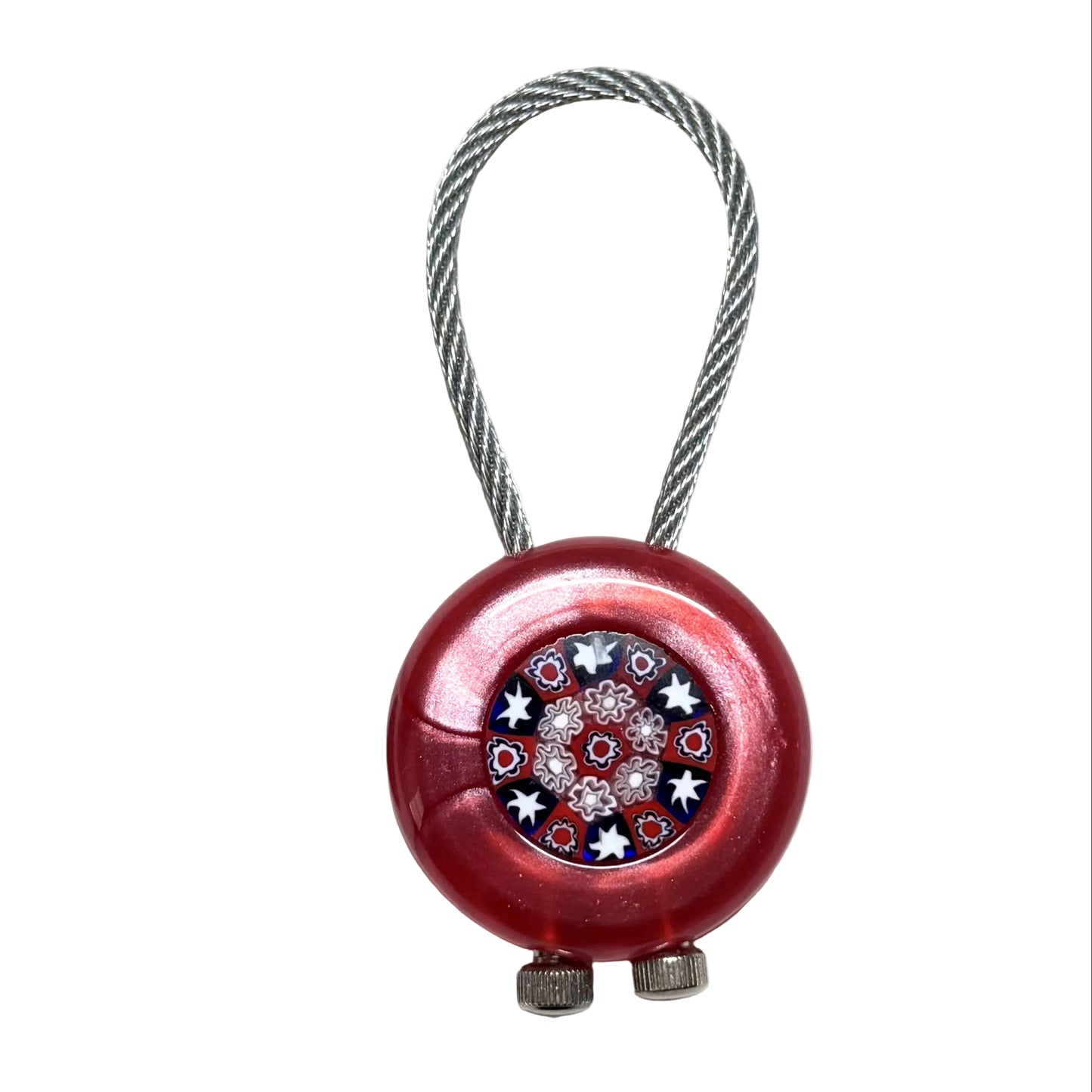 Red decorative object with floral design next  on a white background