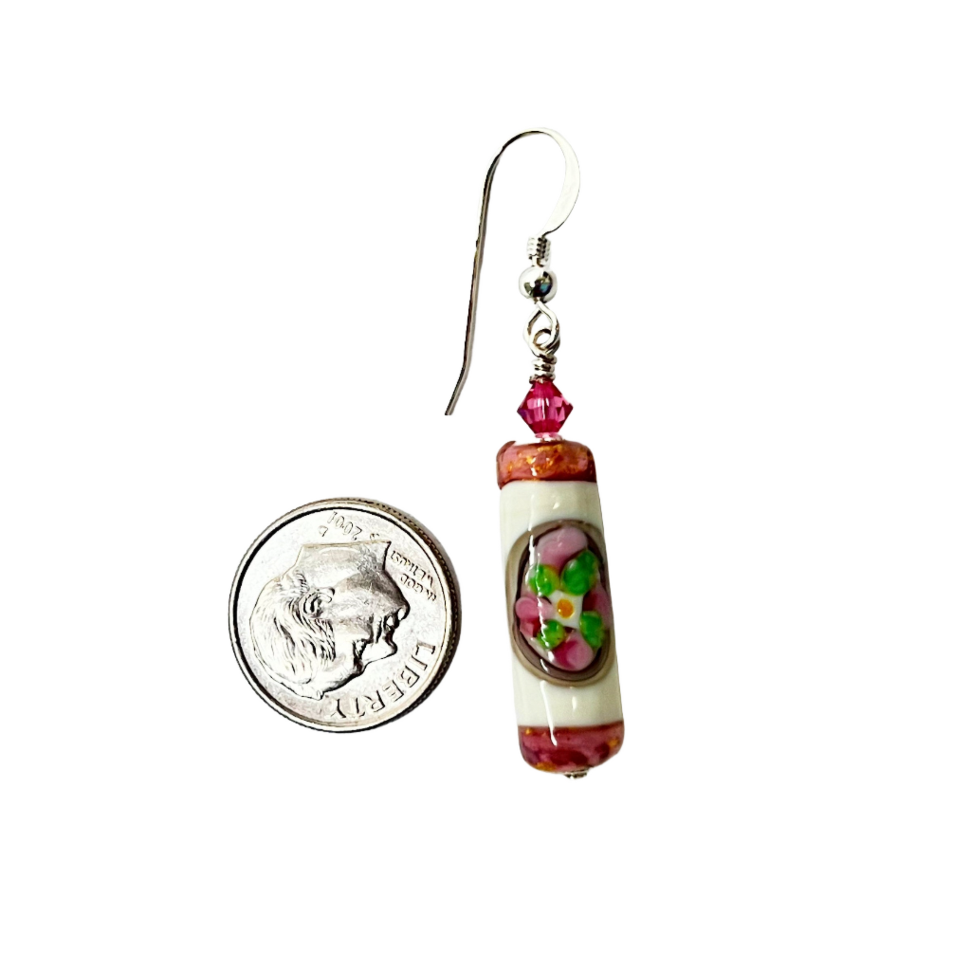 a penny is next to a pair of earrings