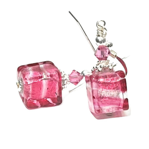 a pair of pink glass earrings on a white background