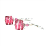 a pair of earrings with pink glass cubes