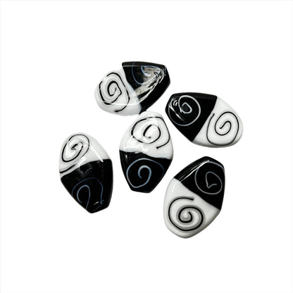 a group of black and white beads on a white background