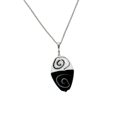 a necklace with a black and white design on it