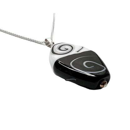 a black and white necklace with a black and white design
