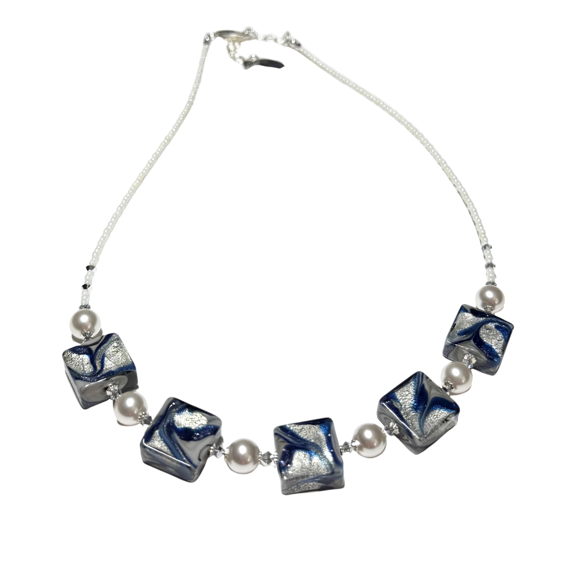 A Murano glass beaded necklace featuring five square glass beads with a blue, white, and gray swirled pattern, separated by small white pearl-like beads on a white cord, shown against a plain white background.
