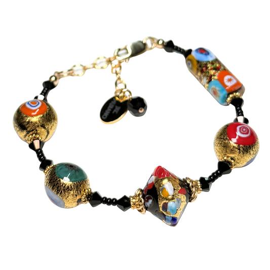 Colorful beaded bracelet with gold accents on a white background