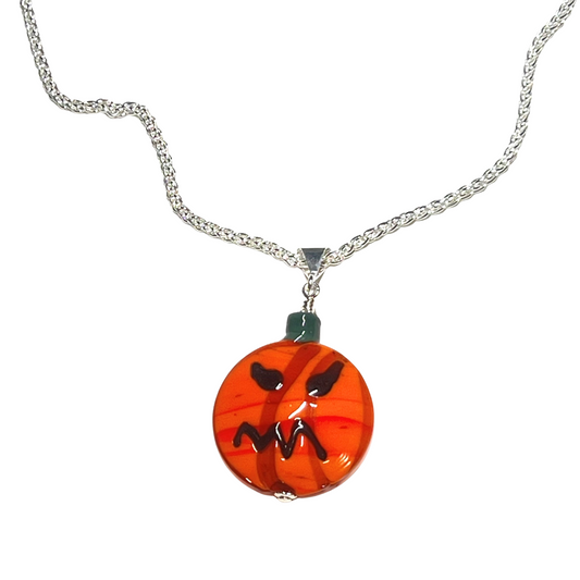 Pumpkin-shaped pendant on a silver chain against a white background