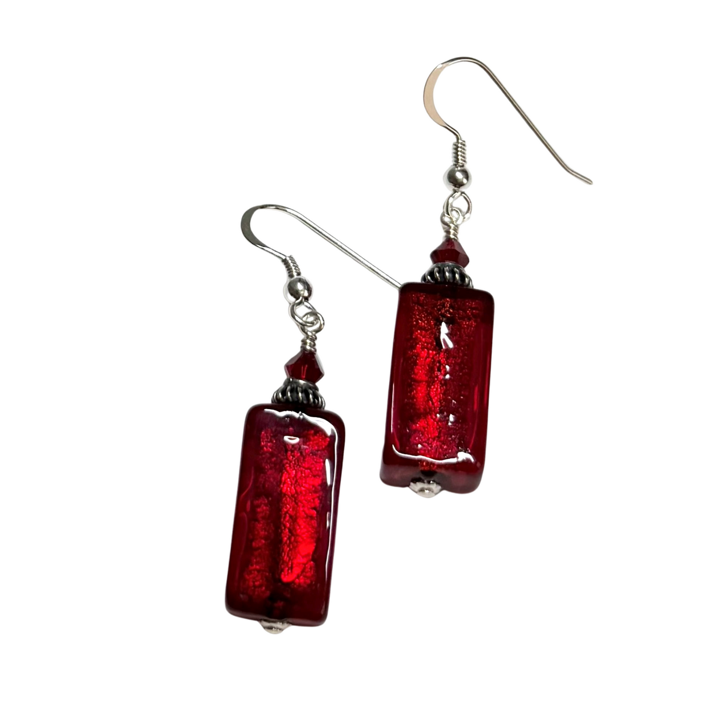 A pair of red rectangular glass drop earrings with silver fishhook wires and small silver spacer beads, shown on a plain white background.