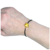 a person wearing a bracelet with a star on it