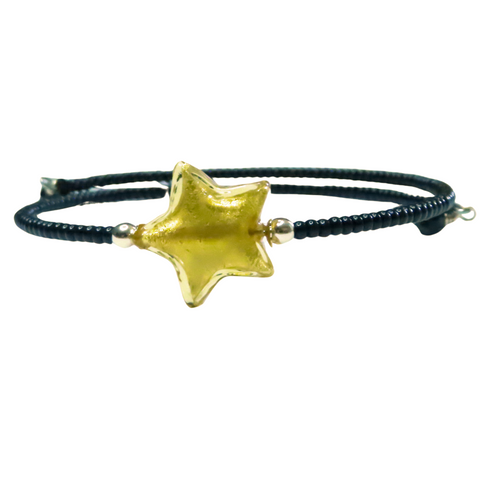 a bangle bracelet with a gold star on it