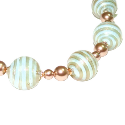 Bracelet with aquamarine and gold beads on a white background