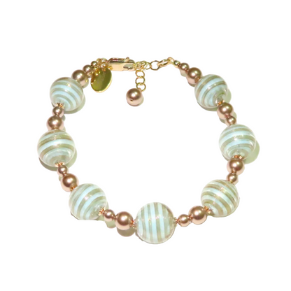 Murano glass bracelet with turquoise blue striped beads on a white background