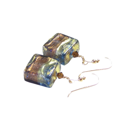 Square glass earrings with gold and blue tones on a white background
