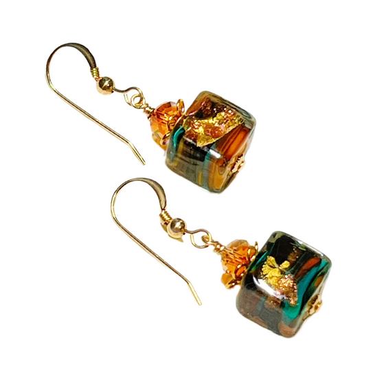 Pair of Murano glass turquoise, gold and green cube-shaped earrings on a white background