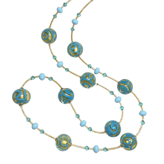 Necklace with turquoise and gold beads on a white background