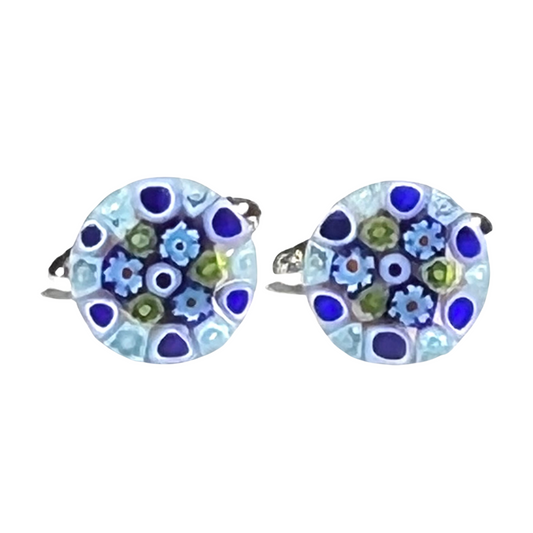 Pair of round cuff links with floral design on a white background
