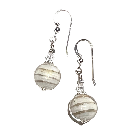 Pair of Murano glass cream round, striped beads on a white background