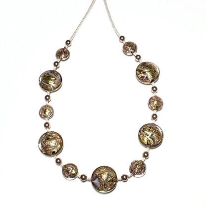 Necklace with round, faceted beads on a white background