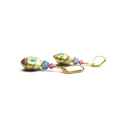 a pair of earrings that are on a white surface