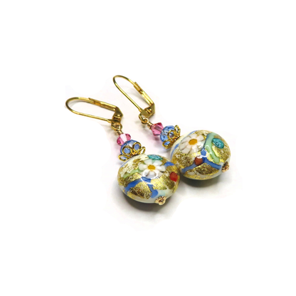 a pair of earrings with flowers on them