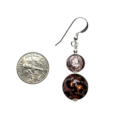 a pair of earrings sitting next to a 