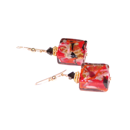 a pair of red and black glass earrings