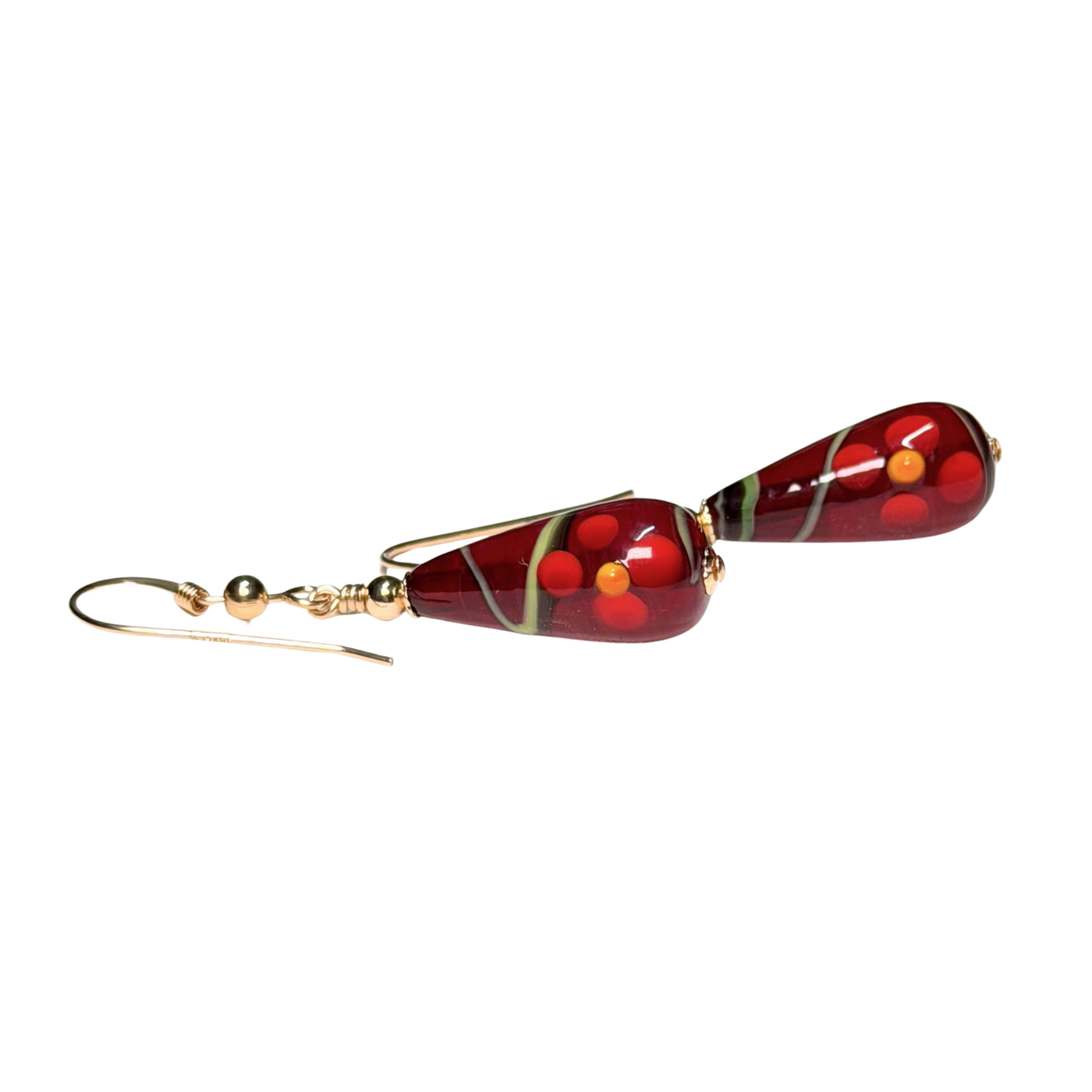 Red teardrop-shaped earrings with gold accents on a white background