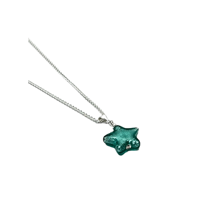 a necklace with a green flower on a chain