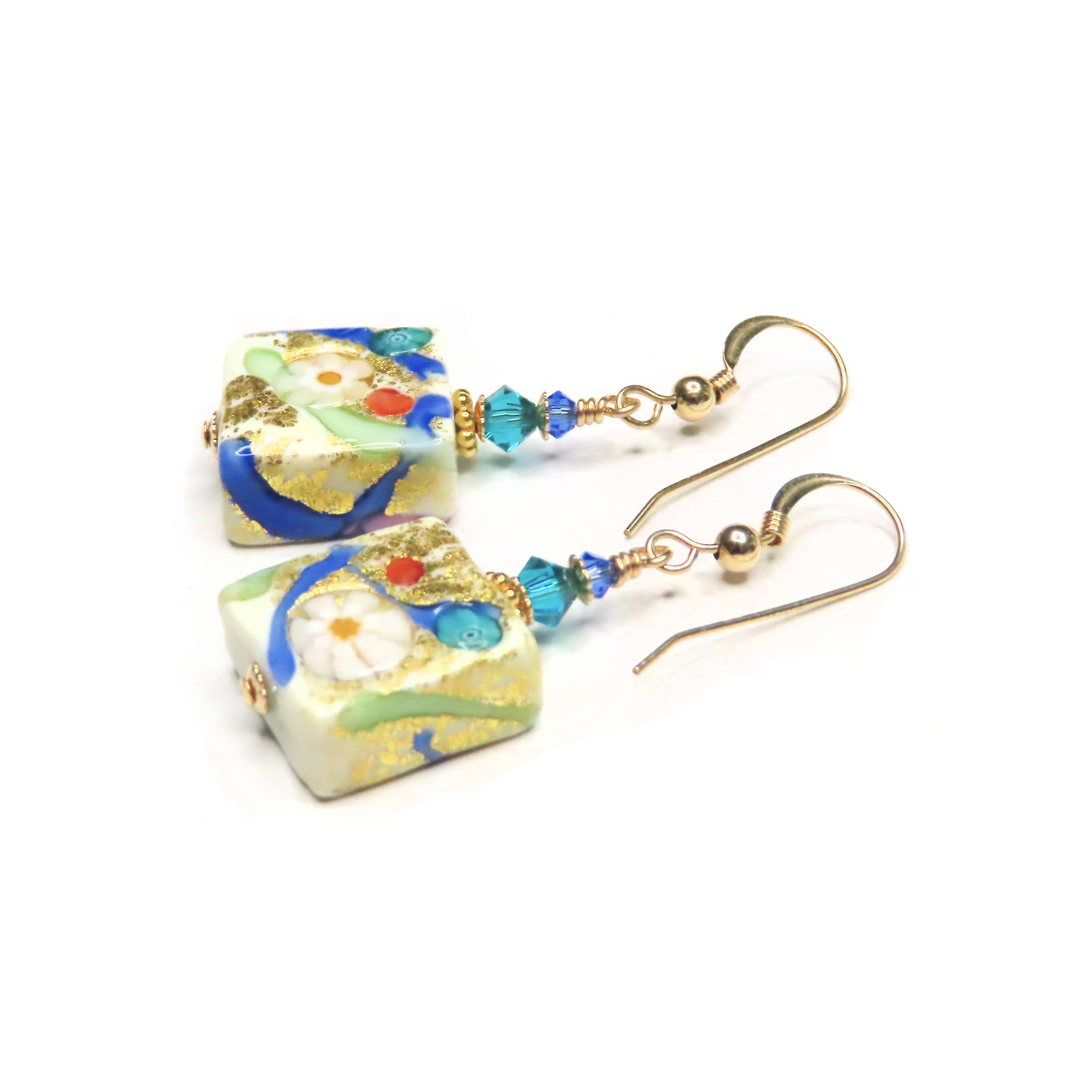 a pair of earrings with blue and white beads