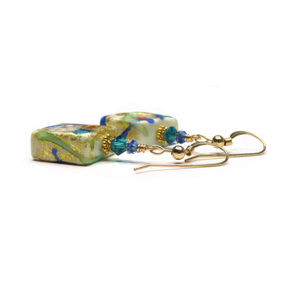 a close up of a pair of earrings on a white background