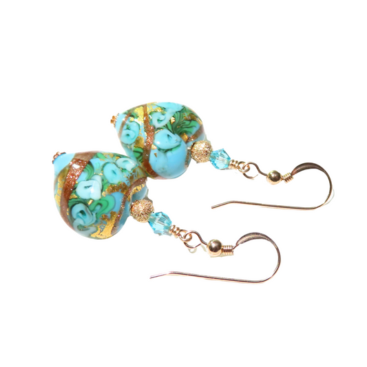 a pair of earrings with blue and green beads