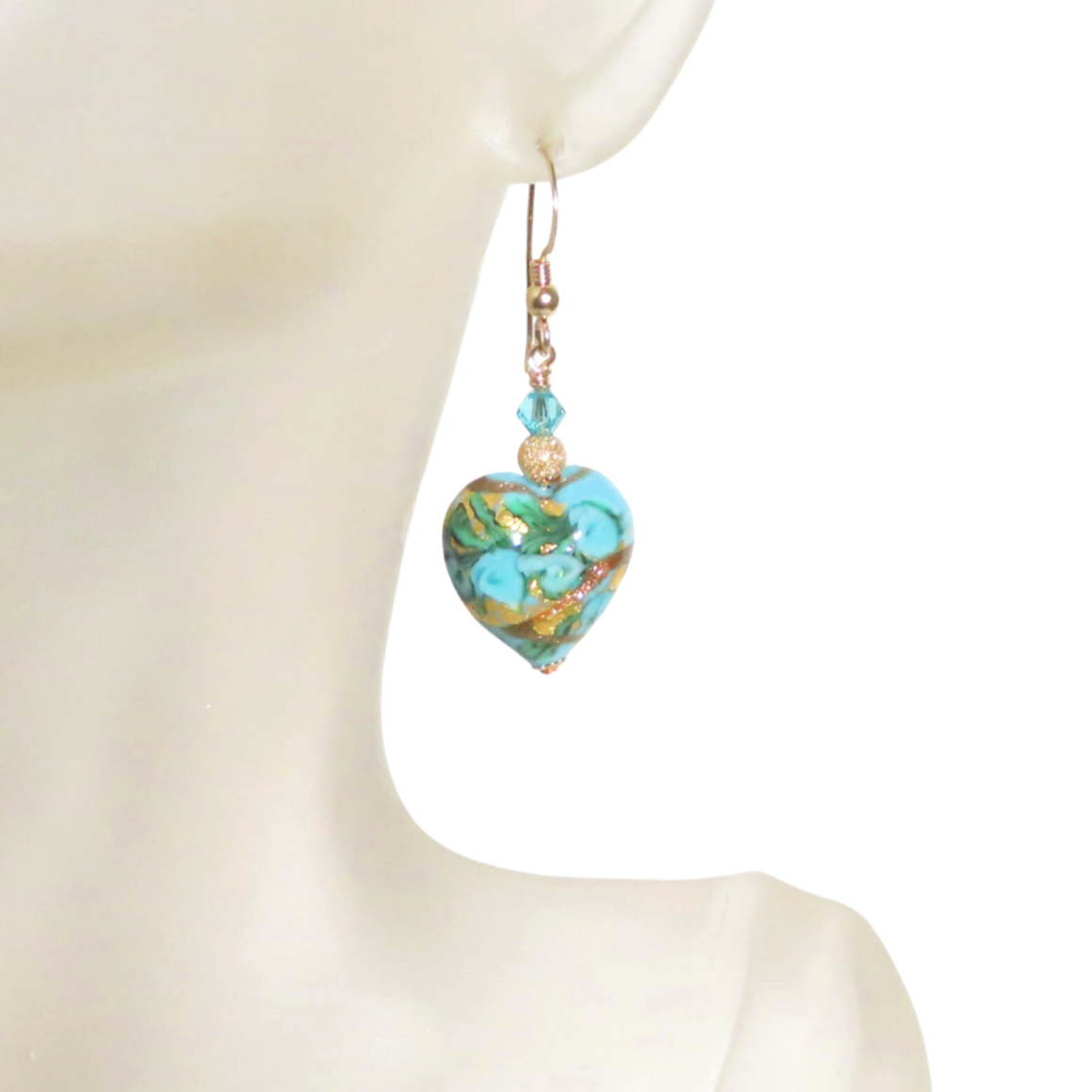 a close up of a person wearing a pair of earrings