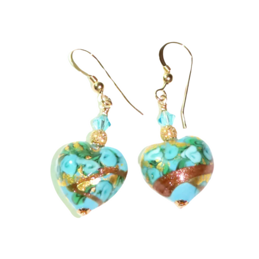 a pair of earrings with a heart shaped design